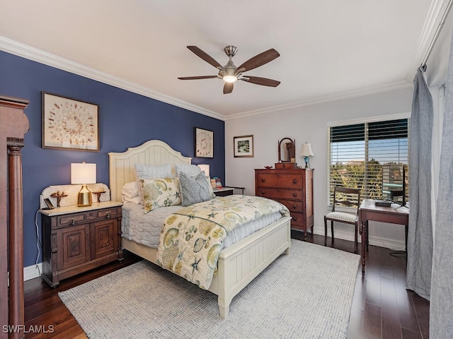 bedroom featuring dark wood finished floors, baseboards, ornamental molding, and a ceiling fan