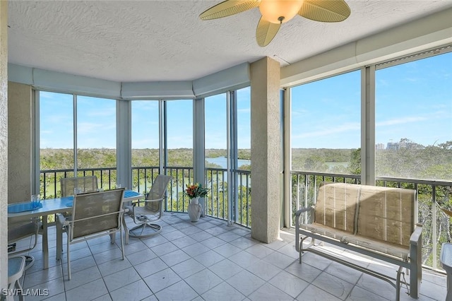 sunroom / solarium with outdoor dining space, a wealth of natural light, and ceiling fan