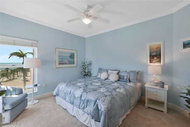 carpeted bedroom featuring crown molding, baseboards, and ceiling fan