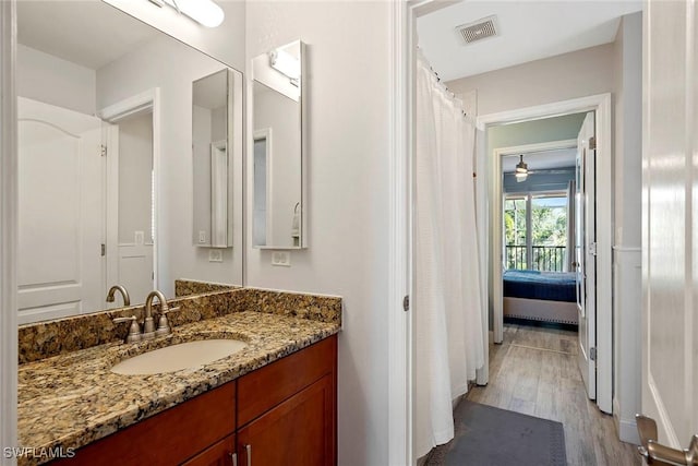 full bath featuring wood finished floors, ceiling fan, ensuite bathroom, vanity, and visible vents