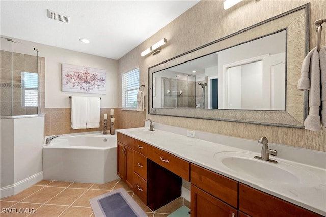 bathroom featuring tile patterned flooring, a sink, a shower stall, and visible vents