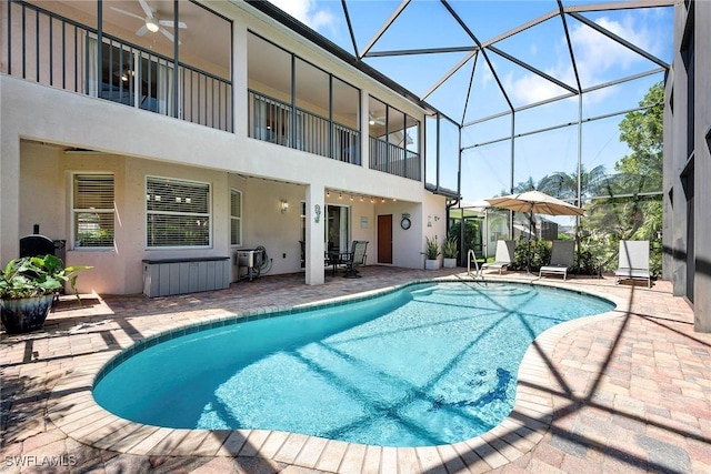 outdoor pool with a lanai and a patio area
