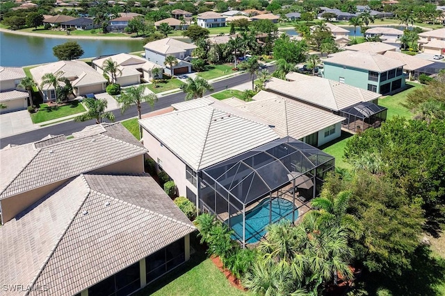 drone / aerial view with a water view and a residential view
