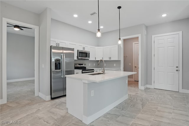 3906 E 10th St, Lehigh Acres, FL 33972 - kitchen featuring stainless steel appliances, a sink, white cabinetry, light countertops, and hanging light fixtures