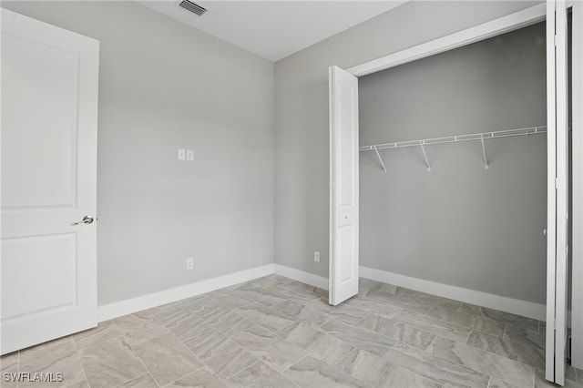 3906 E 10th St, Lehigh Acres, FL 33972 - unfurnished bedroom with a closet and baseboards