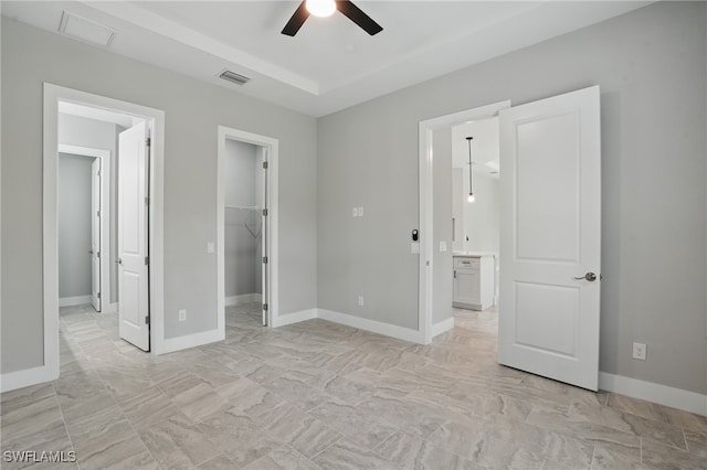 3906 E 10th St, Lehigh Acres, FL 33972 - unfurnished bedroom featuring a spacious closet, baseboards, a ceiling fan, light marble finish flooring, and a closet