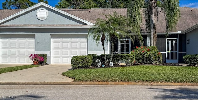 20695 Country Barn Dr, Estero, FL 33928 - ranch-style house featuring a front yard, roof with shingles, stucco siding, driveway, and an attached garage