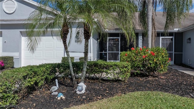 20695 Country Barn Dr, Estero, FL 33928 - view of side of home with stucco siding and a garage