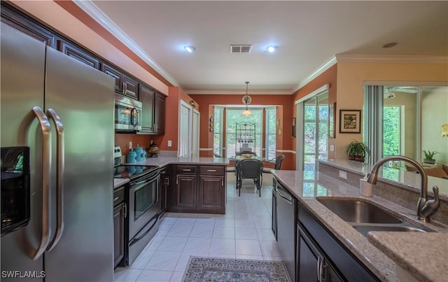 20695 Country Barn Dr, Estero, FL 33928 - kitchen with light tile patterned floors, visible vents, ornamental molding, a sink, and appliances with stainless steel finishes