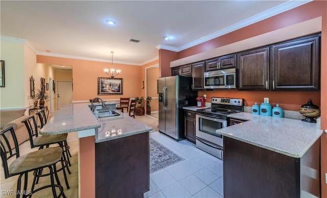 20695 Country Barn Dr, Estero, FL 33928 - kitchen with visible vents, an inviting chandelier, a sink, appliances with stainless steel finishes, and a kitchen bar