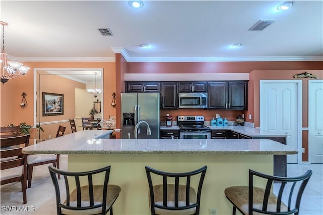 20695 Country Barn Dr, Estero, FL 33928 - kitchen with a breakfast bar, visible vents, stainless steel appliances, and an inviting chandelier