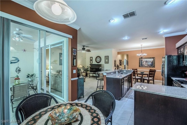 20695 Country Barn Dr, Estero, FL 33928 - dining room featuring crown molding, ceiling fan with notable chandelier, and visible vents
