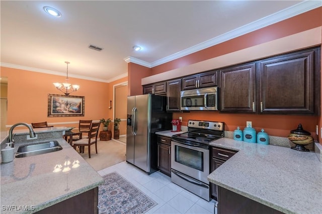 20695 Country Barn Dr, Estero, FL 33928 - kitchen with visible vents, a sink, ornamental molding, dark brown cabinetry, and stainless steel appliances