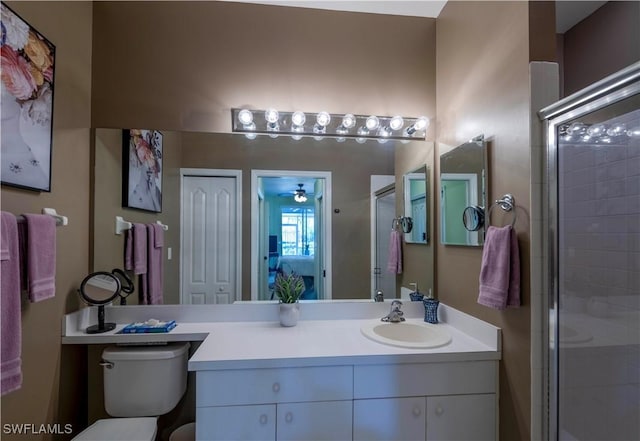 20695 Country Barn Dr, Estero, FL 33928 - full bath featuring a shower stall, toilet, vanity, and a ceiling fan