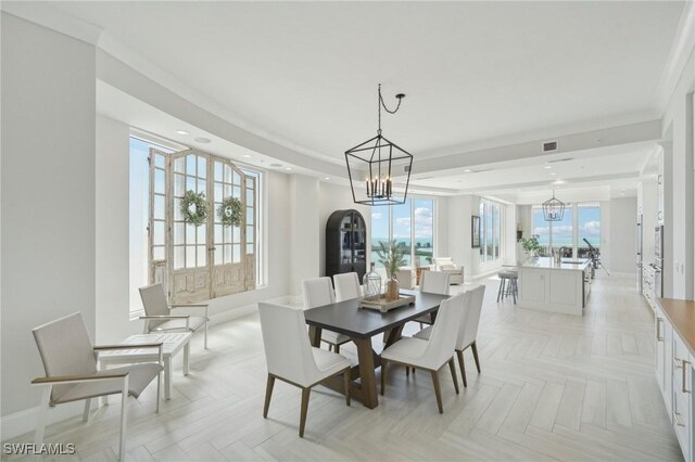 4971 Bonita Bay Blvd Unit Ph2503, Bonita Springs, FL 34134 - dining room featuring a chandelier, a raised ceiling, healthy amount of natural light, and recessed lighting