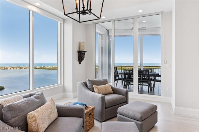 4971 Bonita Bay Blvd Unit Ph2503, Bonita Springs, FL 34134 - living room with a chandelier, recessed lighting, a water view, and light wood-style floors