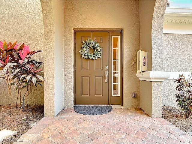 10271 Glastonbury Cir Unit 202, Fort Myers, FL 33913 - doorway to property featuring stucco siding