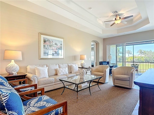 10271 Glastonbury Cir Unit 202, Fort Myers, FL 33913 - living area featuring arched walkways, a tray ceiling, and ceiling fan