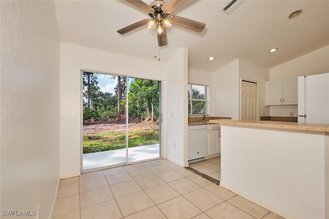 kitchen with white dishwasher, light countertops, white cabinets, and recessed lighting