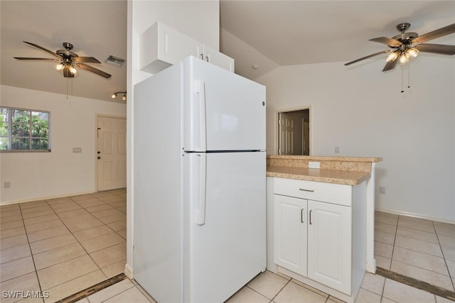 kitchen featuring ceiling fan, freestanding refrigerator, vaulted ceiling, and visible vents