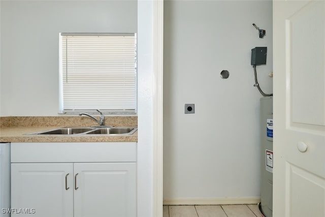 laundry area featuring light tile patterned flooring, laundry area, a sink, baseboards, and electric dryer hookup