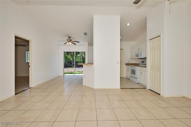 unfurnished living room with baseboards, ceiling fan, and light tile patterned flooring