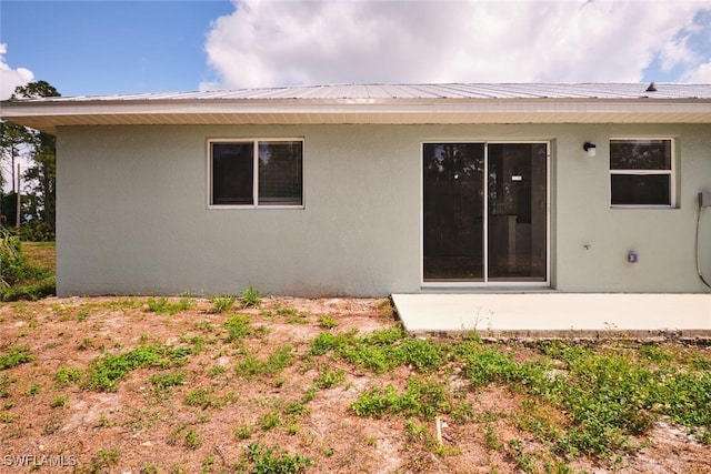 back of house with a patio and stucco siding