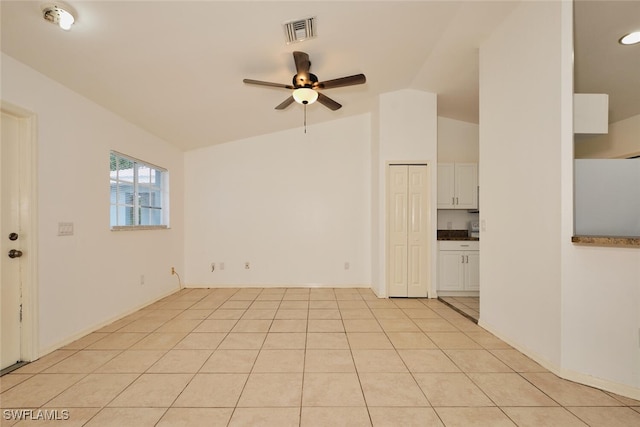 unfurnished room featuring visible vents, ceiling fan, lofted ceiling, and light tile patterned flooring