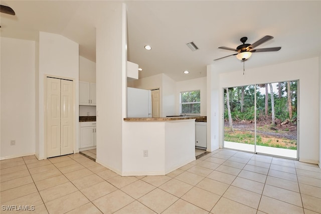 kitchen with white cabinetry, a ceiling fan, visible vents, and light tile patterned floors