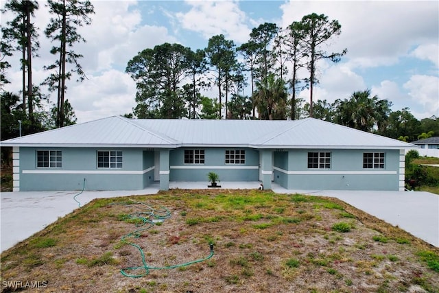 single story home with concrete driveway and stucco siding