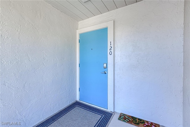 property entrance with stucco siding