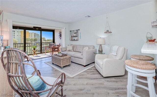 living room featuring wood finished floors and visible vents