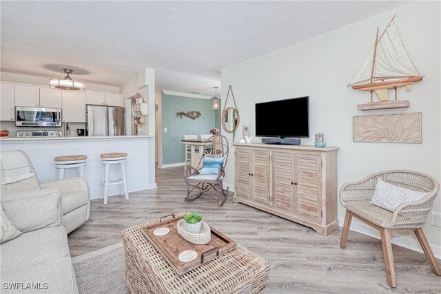 living area with baseboards and light wood-type flooring
