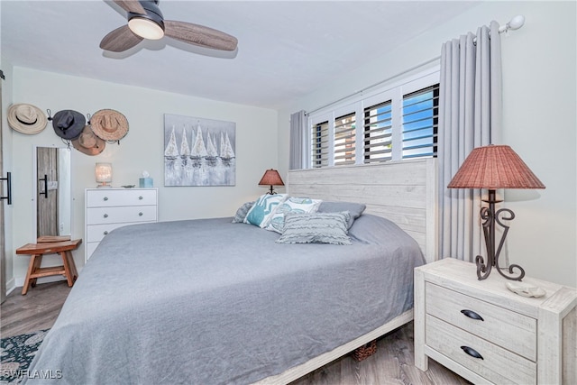 bedroom with a ceiling fan and wood finished floors