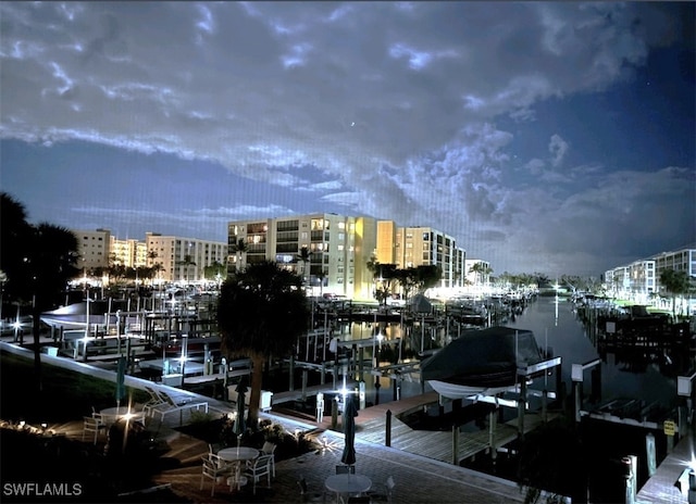 dock area featuring a view of city and boat lift