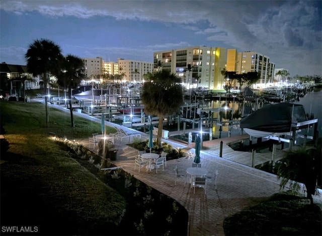 surrounding community with a view of city, boat lift, and a boat dock