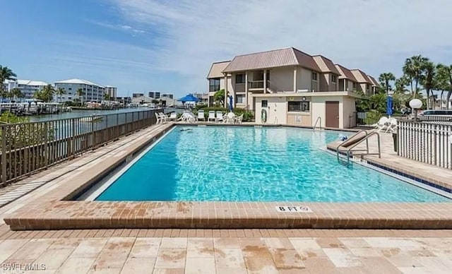 community pool featuring a patio area and fence