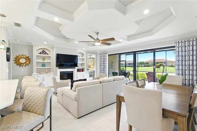 living room featuring visible vents, ornamental molding, built in shelves, and coffered ceiling