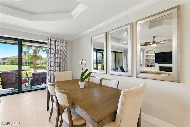 dining space with crown molding, a ceiling fan, light tile patterned flooring, and a healthy amount of sunlight