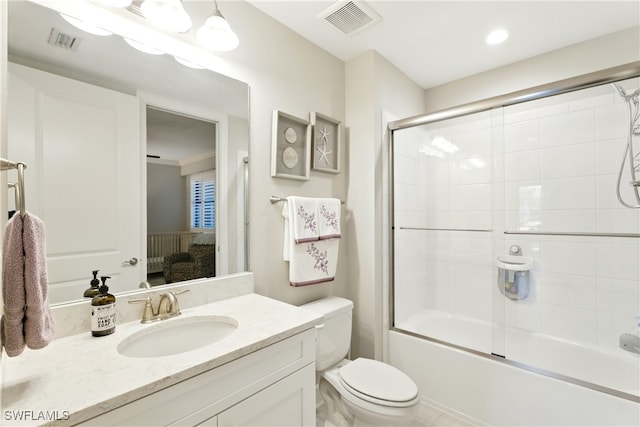 bathroom with visible vents, connected bathroom, toilet, and vanity