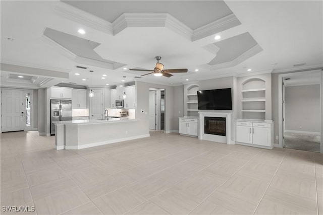 9654 Montelanico Loop Unit 102, Naples, FL 34119 - unfurnished living room featuring ornamental molding, a sink, coffered ceiling, a glass covered fireplace, and a ceiling fan