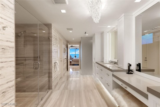 ensuite bathroom with ensuite bath, a notable chandelier, visible vents, and a shower stall