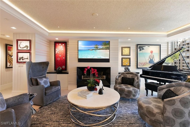 living area featuring recessed lighting, a raised ceiling, and a textured ceiling