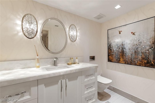 bathroom with visible vents, toilet, and vanity
