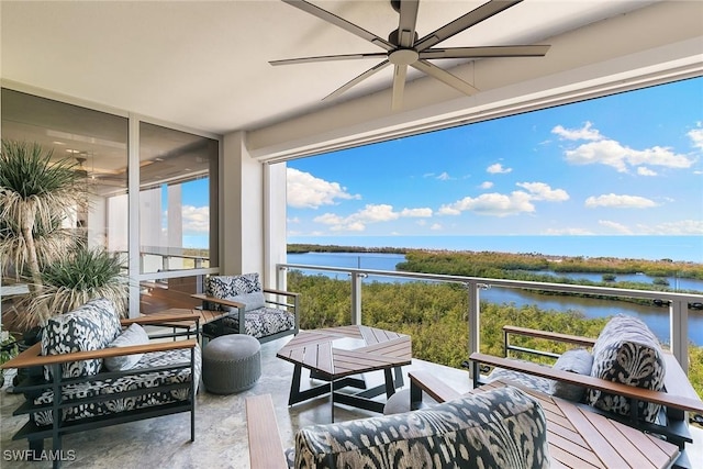 sunroom / solarium with a wall of windows, concrete flooring, and a water view