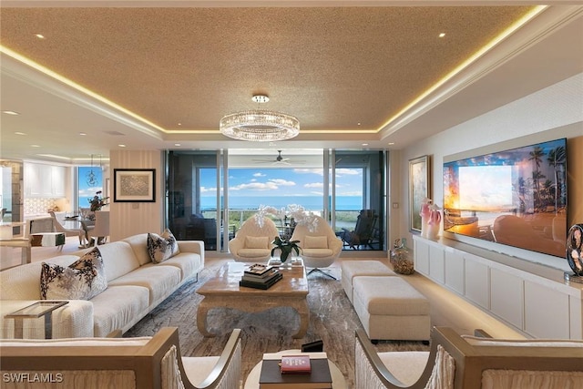 living room featuring a raised ceiling, a textured ceiling, and a ceiling fan
