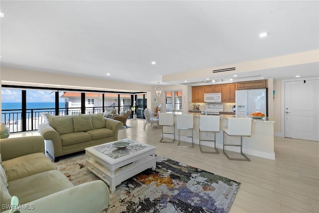 3333 Gulf Shore Blvd N Unit 4, Naples, FL 34103 - living room featuring visible vents, recessed lighting, baseboards, and a water view