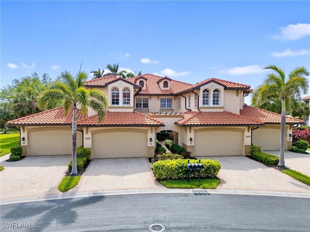 11239 Bienvenida Ct Unit 102, Fort Myers, FL 33908 - mediterranean / spanish house with a tiled roof, driveway, and stucco siding