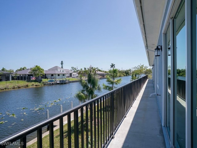 balcony featuring a residential view and a water view