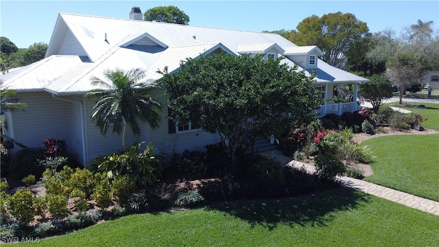 234 W Circle Dr, Clewiston, FL 33440 - view of side of home with a lawn and a chimney